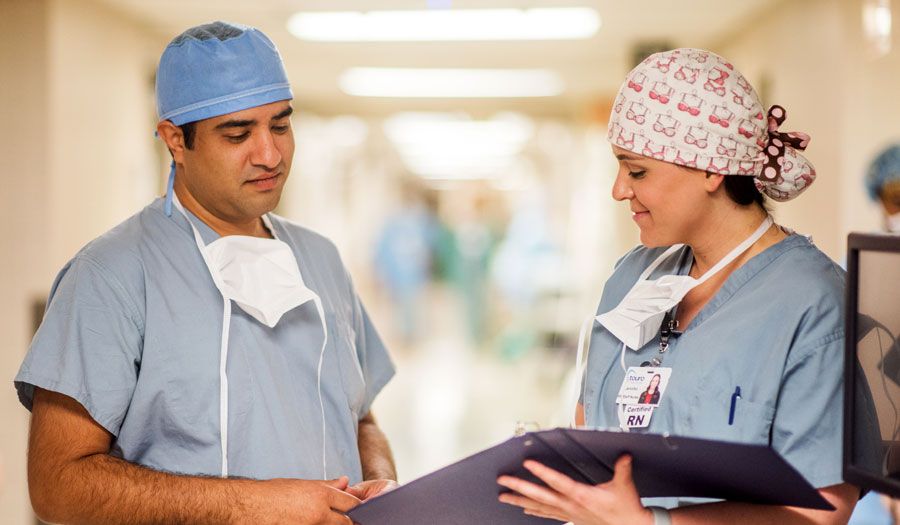 photo of our breast reconstruction surgeon, Dr. Ravi Tandon, and a staff member