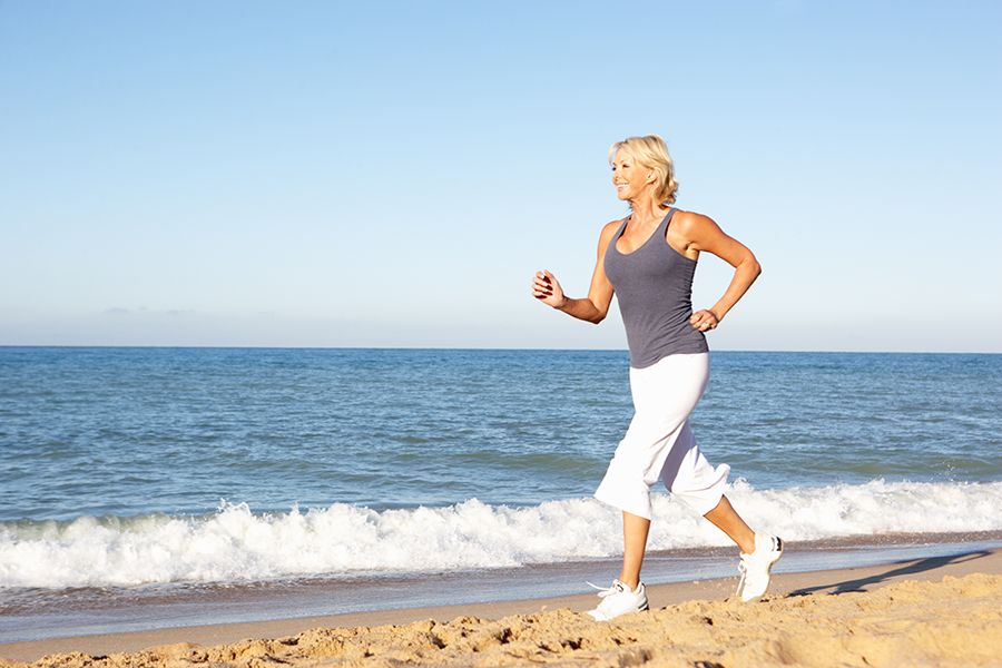 a woman running on the beach